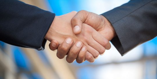 business men and women shaking hands